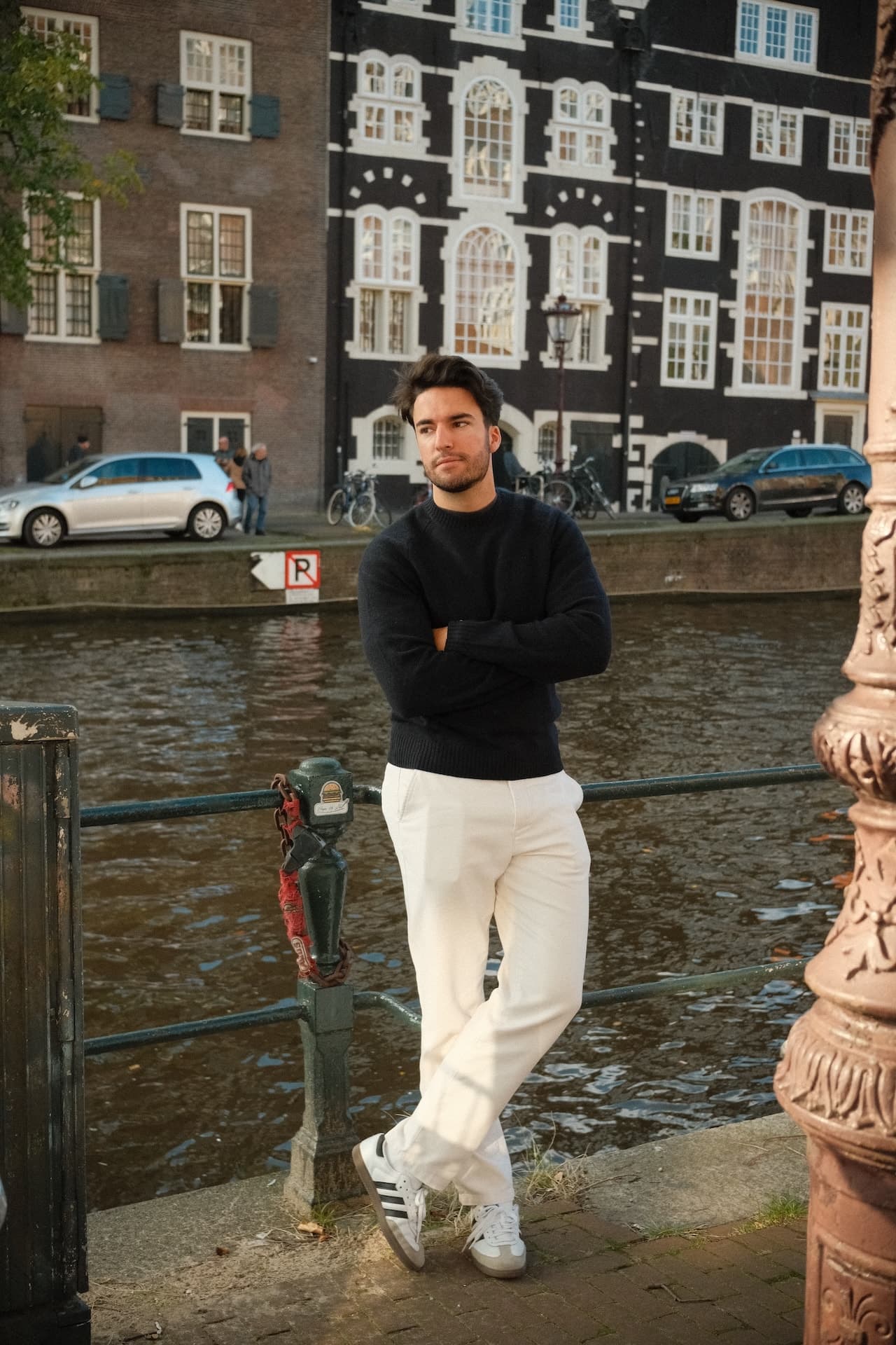 Kacim Fedjkhi leaning against a railing on a downtown street